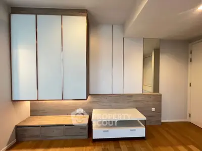 Modern living room with sleek built-in storage and wooden flooring