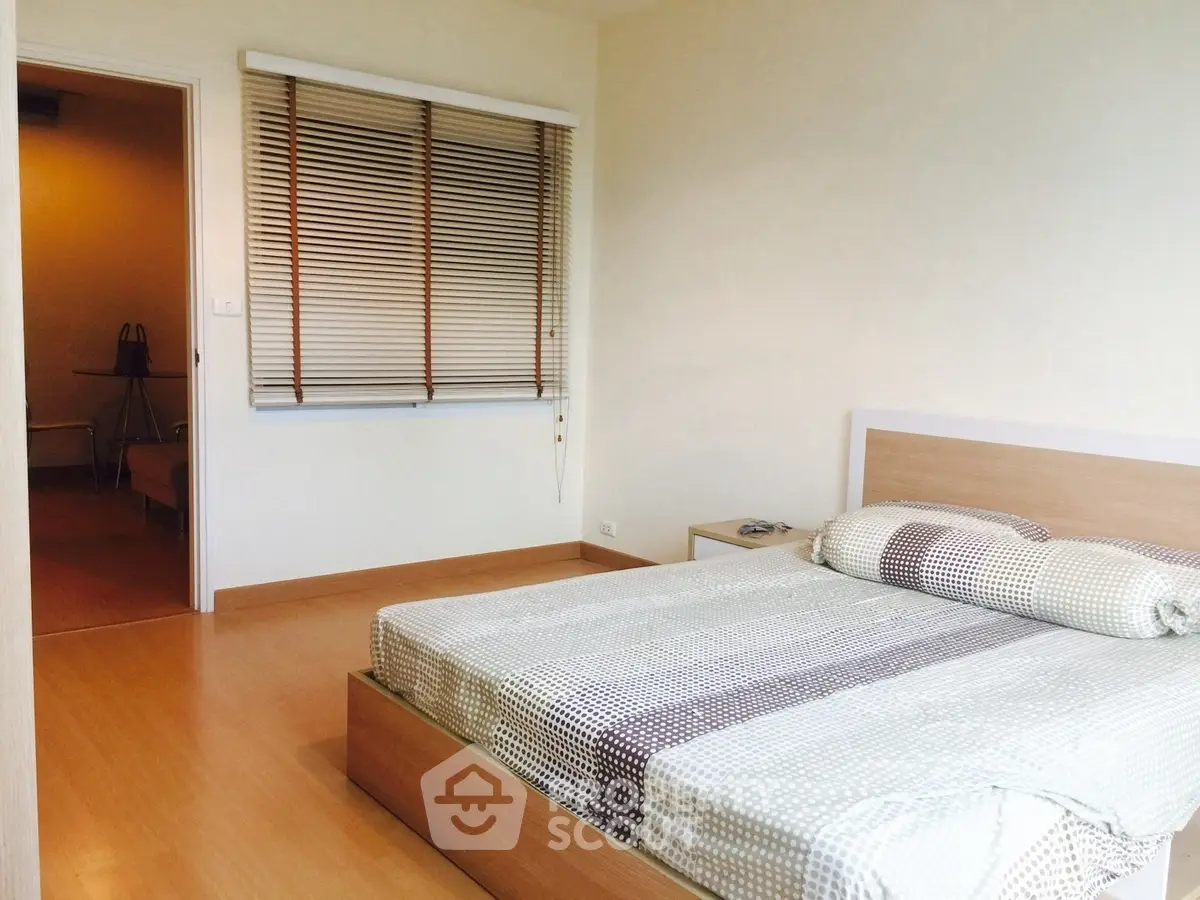 Modern bedroom with wooden flooring and stylish blinds