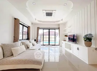 Spacious modern living room with elegant decor and pool view