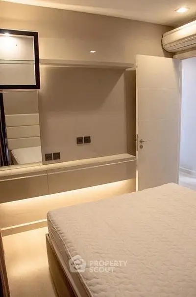 Modern bedroom with sleek design and ambient lighting