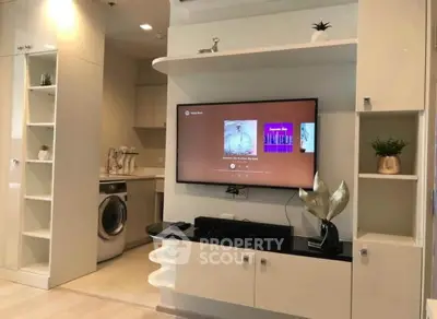 Modern living room with built-in entertainment center and laundry area