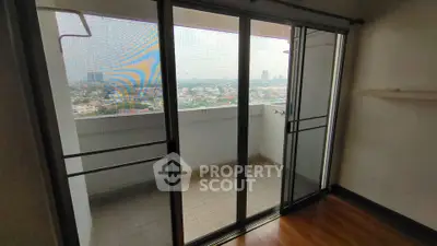 Spacious balcony with sliding glass doors offering panoramic city views.