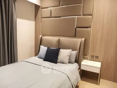 Modern bedroom with stylish padded headboard and cozy bedding