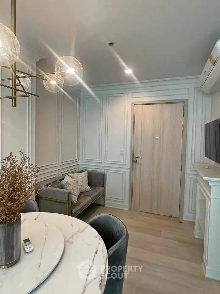 Elegant living room with modern decor and stylish lighting in a cozy apartment.