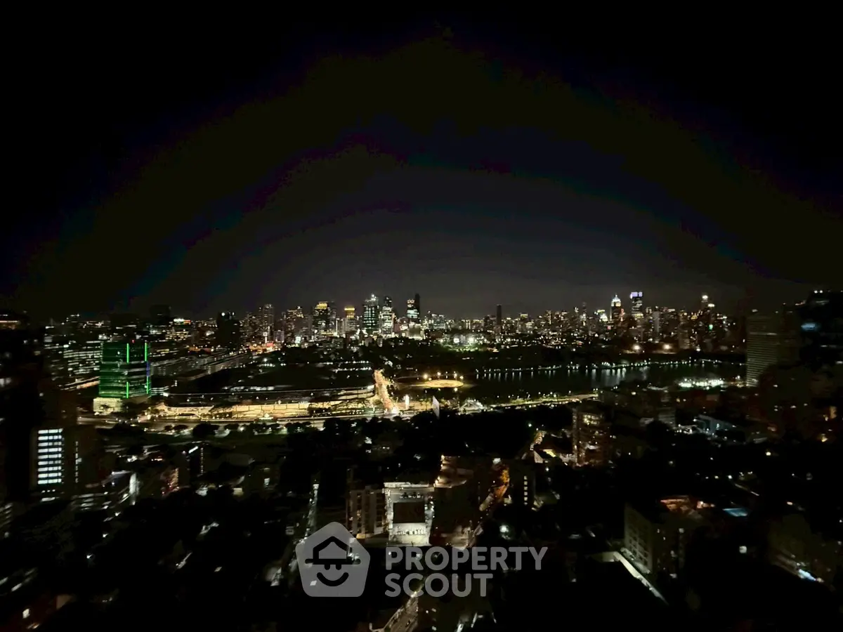 Stunning city skyline view at night with illuminated buildings and river
