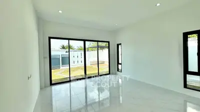 Spacious modern living room with large windows and garden view