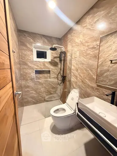 Modern bathroom with elegant tile design and sleek fixtures