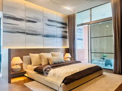 Luxurious modern bedroom with elegant decor and large glass doors leading to a stylish balcony.