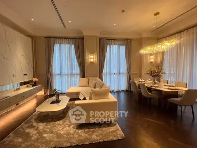 Luxurious living room with elegant dining area, featuring plush seating and modern lighting.