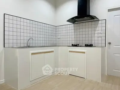 Modern kitchen with sleek white cabinets and gas stove in a stylish corner layout.
