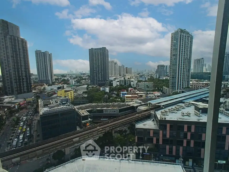 Stunning cityscape view from high-rise building with modern skyline and blue sky.