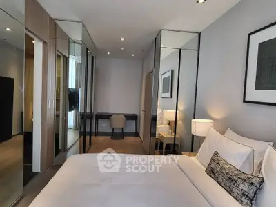 Luxurious modern bedroom with mirrored closets and elegant decor