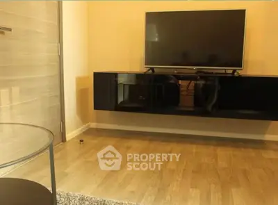 Modern living room with mounted TV and sleek wooden flooring