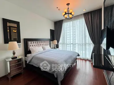 Luxurious bedroom with elegant decor and large windows offering stunning city views.