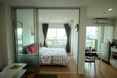 Modern bedroom with sliding glass doors and city view in a stylish apartment