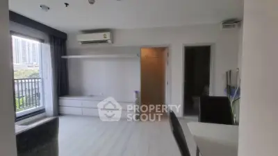 Modern living room with balcony view and sleek air conditioning unit.