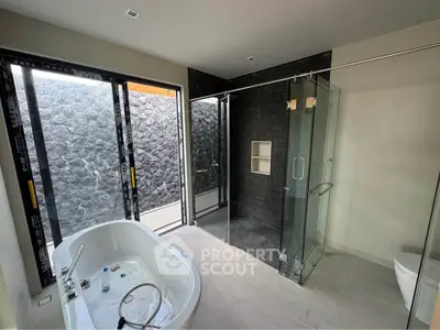 Luxurious modern bathroom with glass shower and freestanding tub