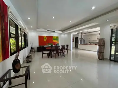 Spacious modern living room with open kitchen and vibrant decor