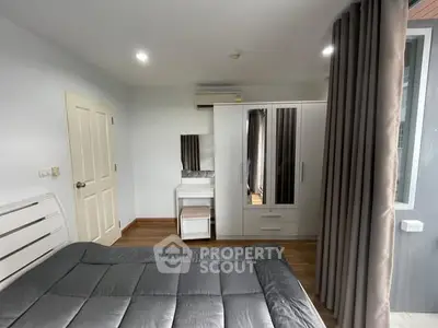 Modern bedroom with sleek furniture and ample natural light