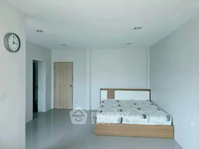 Spacious minimalist bedroom with modern design and natural light