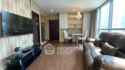 Spacious living room with elegant decor and large windows offering natural light.