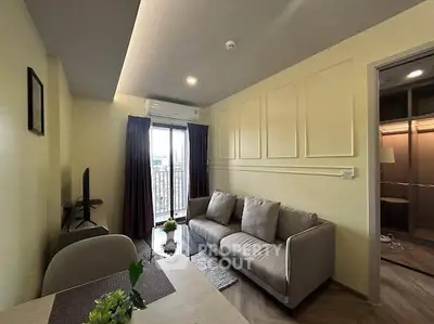 Modern living room with cozy sofa and natural light from balcony