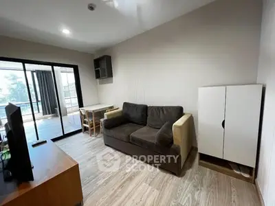 Modern living room with balcony access and stylish furnishings