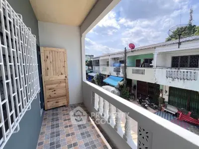 Charming balcony with tiled floor and neighborhood view, perfect for relaxation and enjoying the outdoors.