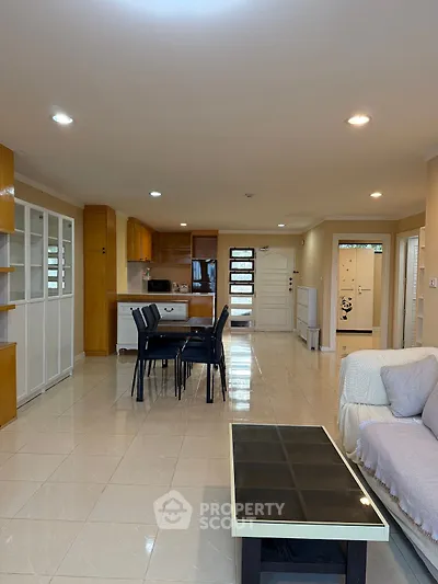 Spacious open-plan living room with modern kitchen and dining area, perfect for family gatherings.