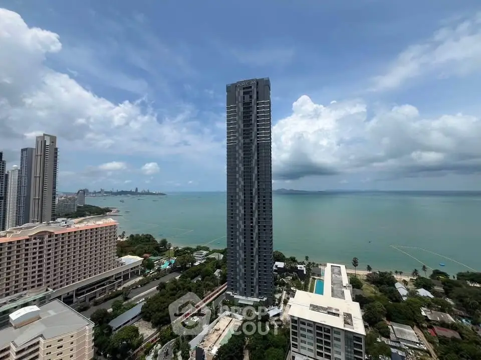 Stunning high-rise building with breathtaking ocean view and lush surroundings.