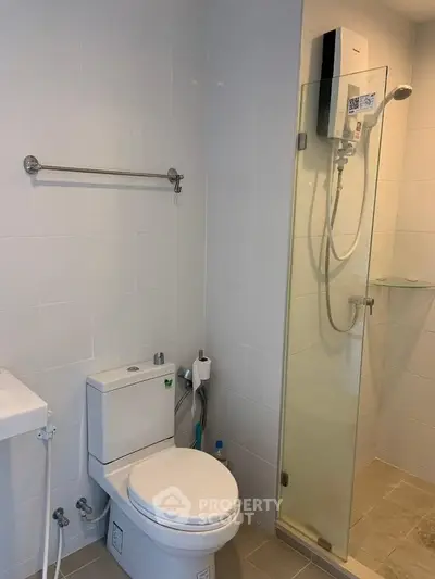 Modern bathroom with glass shower and sleek fixtures in a contemporary apartment.