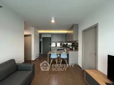 Modern open-plan living room with sleek kitchen and stylish furniture