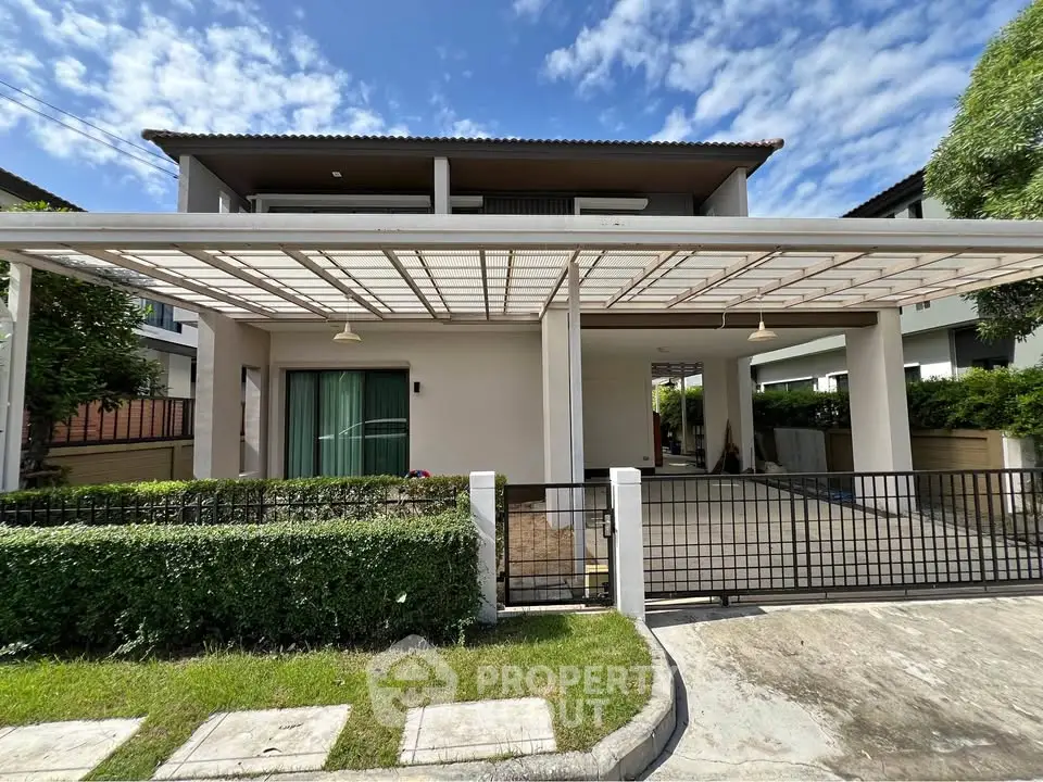 Modern two-story house with spacious carport and lush greenery