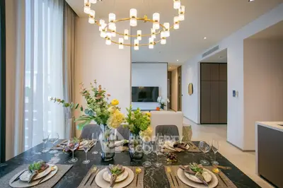 Luxurious modern dining area with elegant chandelier and stylish decor