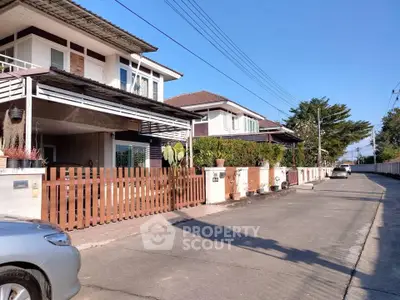 Charming suburban street with modern houses and clear blue sky