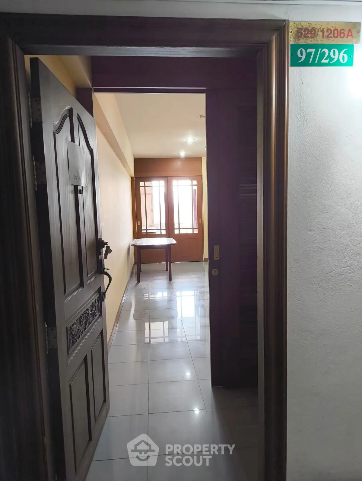 Inviting entrance to a cozy apartment with a glimpse of a bright interior and polished floors.