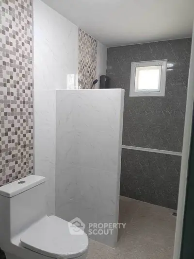 Modern bathroom with stylish tile design and compact layout