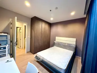 Modern bedroom with wooden wardrobe and natural light