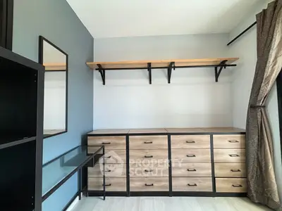 Modern storage room with sleek wooden cabinets and stylish shelving.