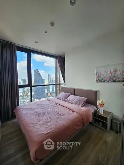 Luxurious bedroom with stunning city view in modern high-rise apartment