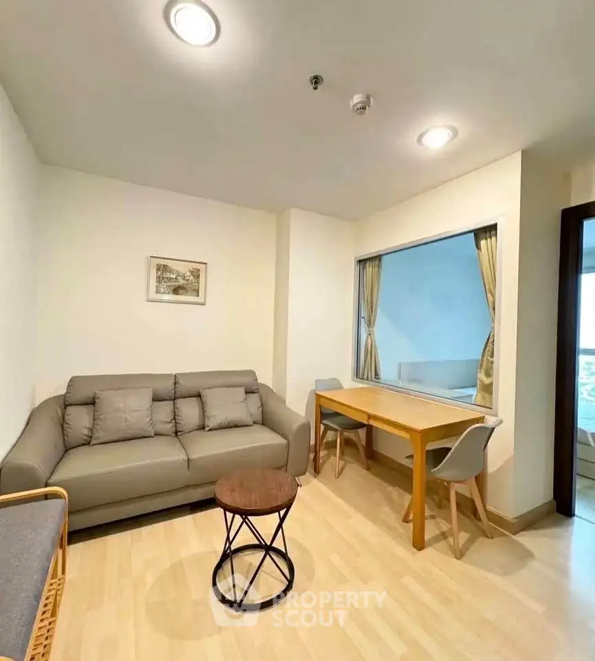 Modern living room with cozy sofa and stylish decor in a bright apartment.