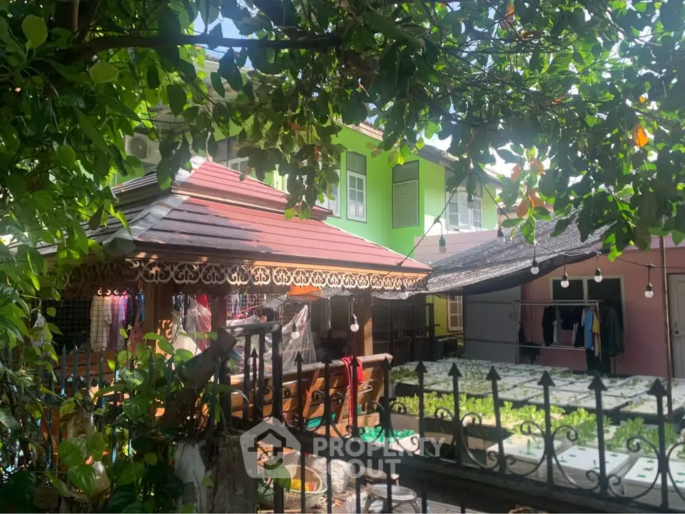 Charming garden view of a traditional house with lush greenery and cozy outdoor space.