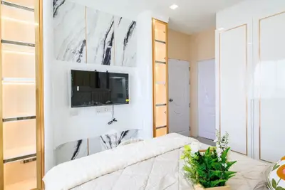 Luxurious bedroom with modern TV setup and elegant decor