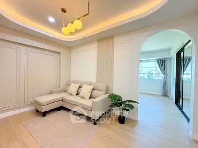 Elegant living room with modern lighting and cozy beige sofa in a stylish apartment.