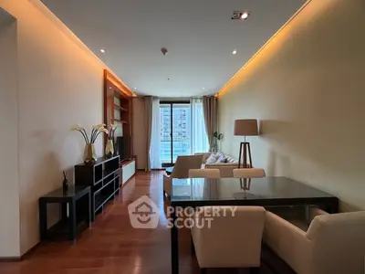 Spacious modern living room with elegant decor and large windows offering city views.