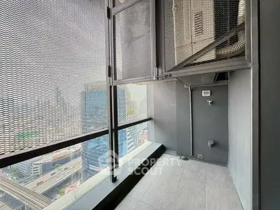 Modern high-rise balcony with city view and sleek metal railing.