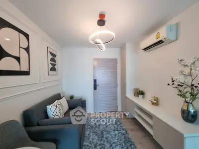 Modern living room with stylish decor and air conditioning unit