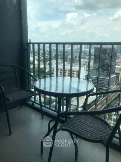 Stunning high-rise balcony with panoramic city views, perfect for relaxation and enjoying the skyline.