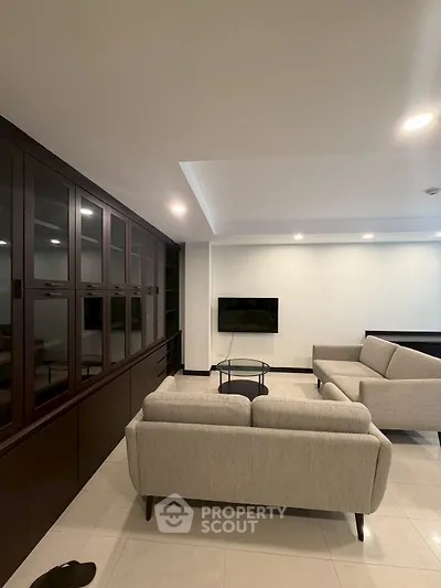 Spacious modern living room with sleek furniture and built-in cabinetry