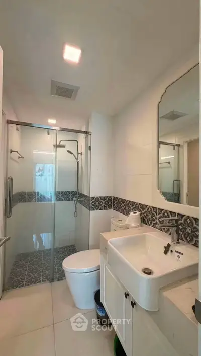 Modern bathroom with glass shower and stylish tile accents